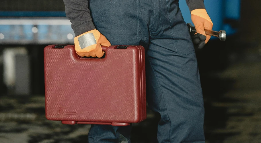 technician holding toolbox