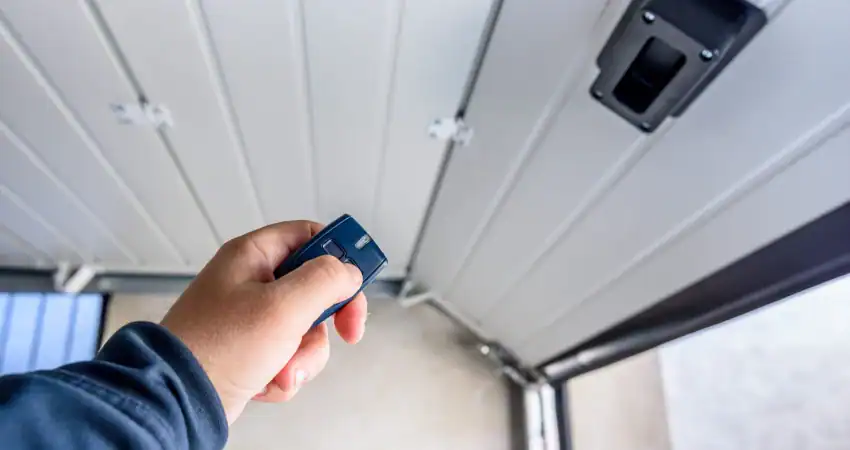 man opening garage door with remote