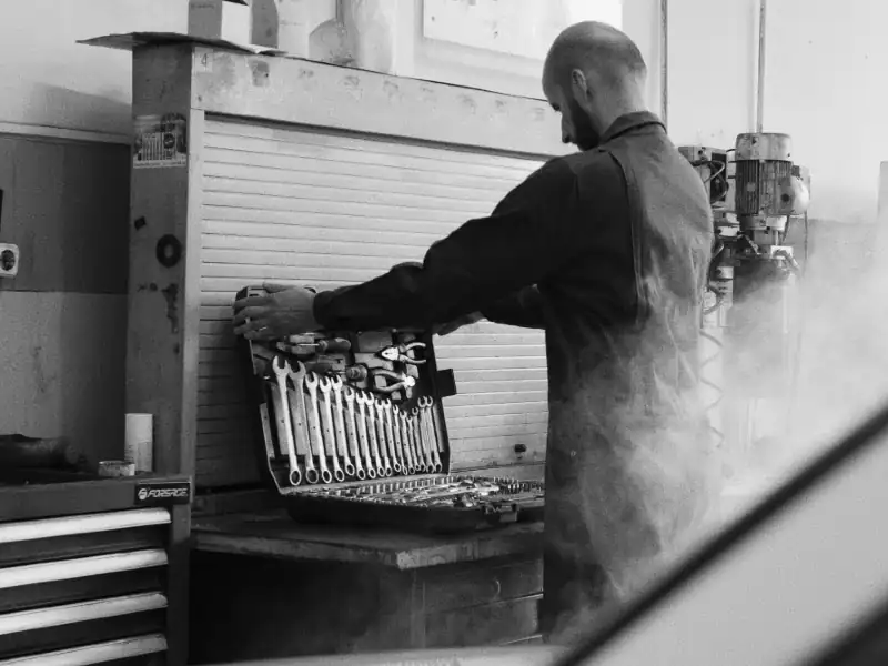 Professional technician preparing tools for garage door repair service